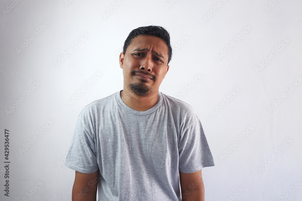 asian man crying with sad face expression, isolated in white asian man crying with sad face expression, isolated in white