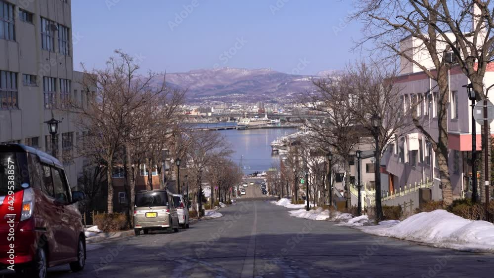 Famous view of Hachiman-Zaka slope towards Hakodate port in Hokkaido during winter Famous view of Hachiman-Zaka slope towards Hakodate port in Hokkaido during winter