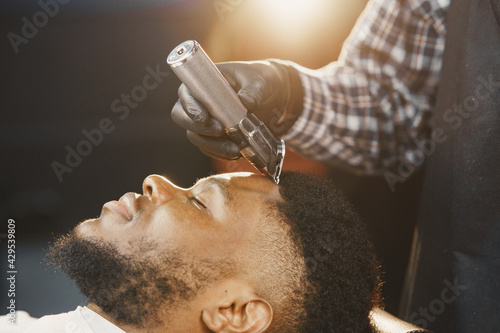 Young African-american man visiting barbershop