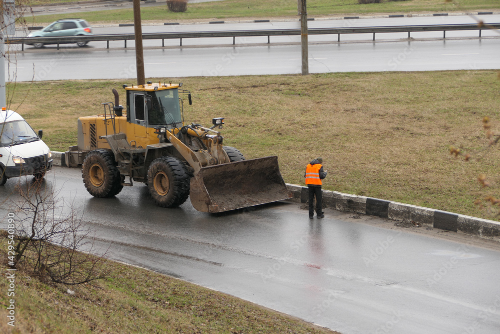 It's a clean city. People, workers clean the roads. Roadworks and road cleaning. High quality photo It's a clean city. People, workers clean the roads. Roadworks and road cleaning. High quality photo