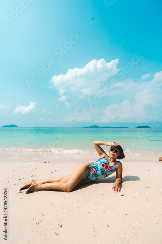 A woman relaxing on the beach in summer © artrachen