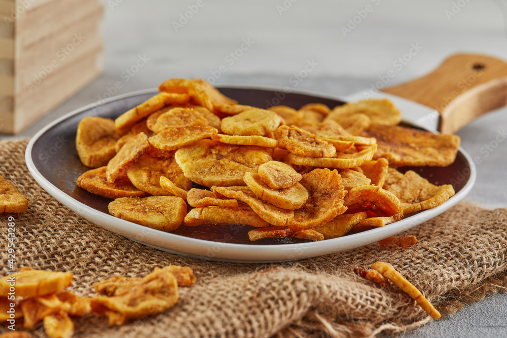 Banana chips healthy food, dry fruit and healthy vegetable chips, healthy vegan burlap snacks in plate Banana chips healthy food, dry fruit and healthy vegetable chips, healthy vegan burlap snacks in plate