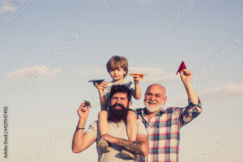 Happy fathers day. Happy three generations of men have fun and smiling on blue sky background. Grandfather playtime. Airplane ready to fly.