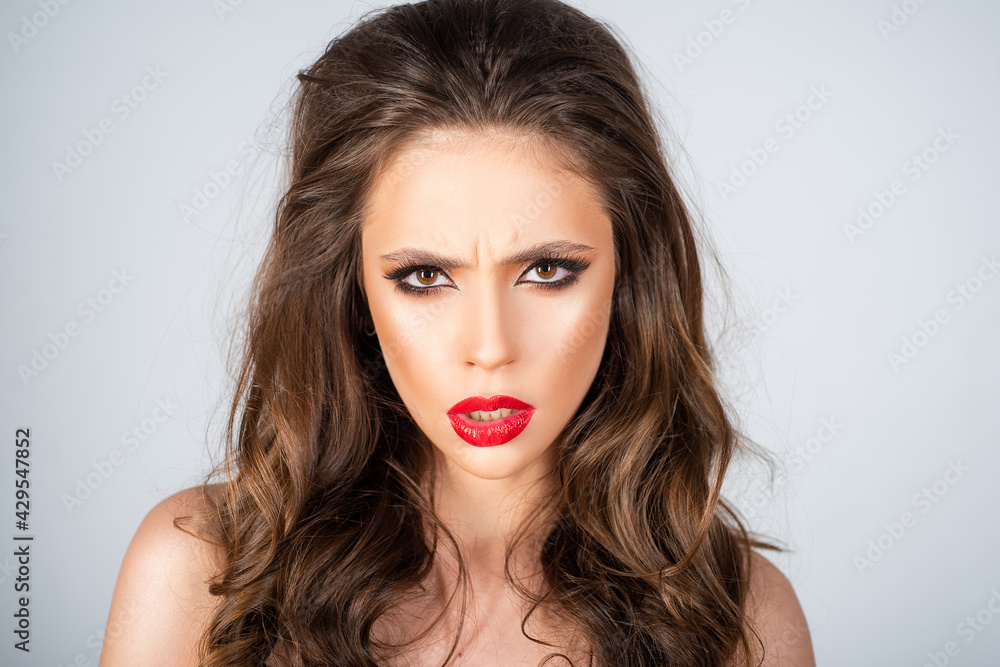 Portrait of beautiful woman with black eyes makeup and red lips. Pretty girl with long black hair. Closeup face of fashion woman. Portrait of beautiful woman with black eyes makeup and red lips. Pretty girl with long black hair. Closeup face of fashion woman.