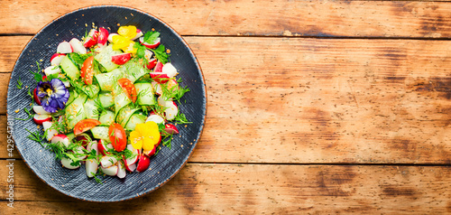 Spring vegetable salad with flowers,space for text