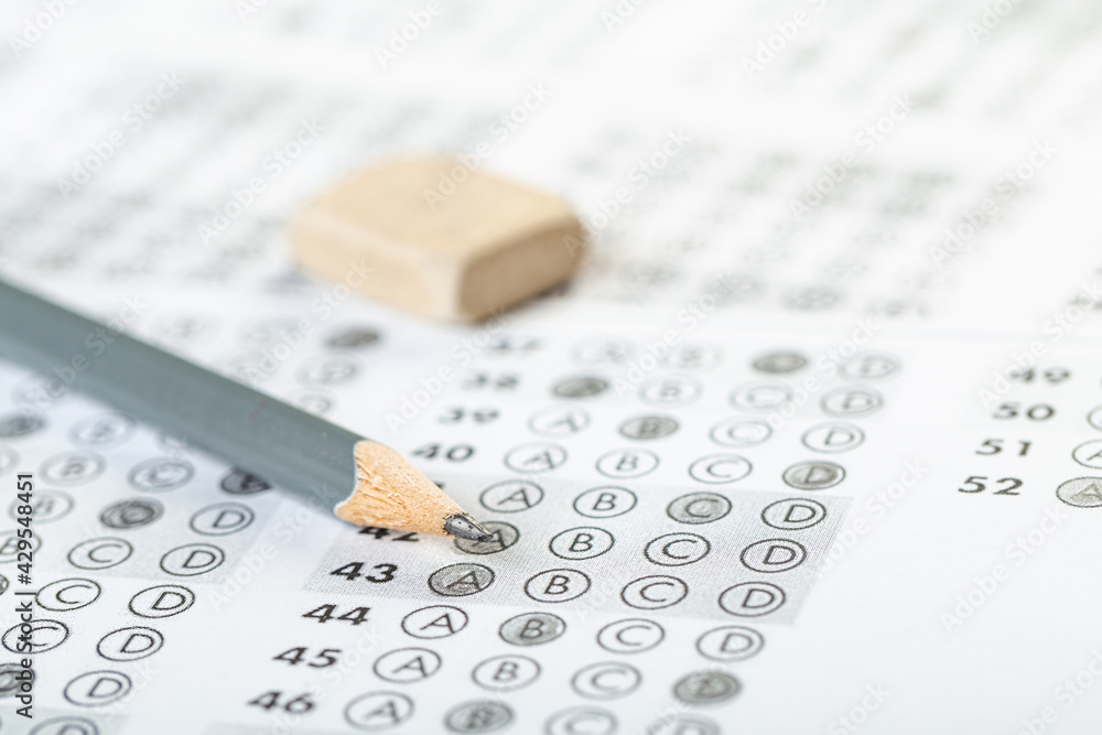 testing in exercise and exam paper. computer sheet with pencil in school test room, education concept. testing in exercise and exam paper. computer sheet with pencil in school test room, education concept.