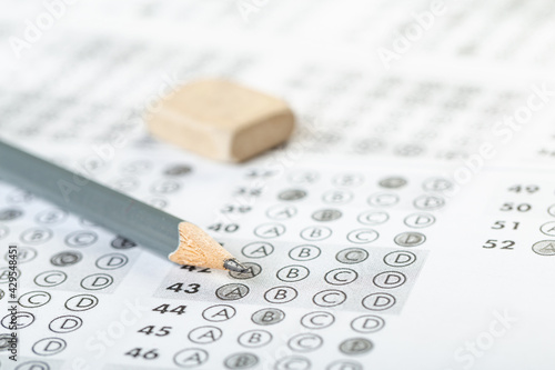 testing in exercise and exam paper. computer sheet with pencil in school test room, education concept.