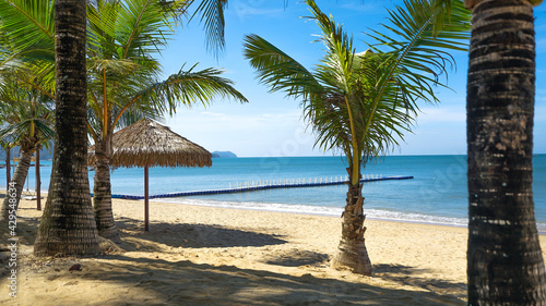 Umbrella Hut and Coconut Palm Tree on the Beach. Koa Lak  Pnag Ng  Thailand.