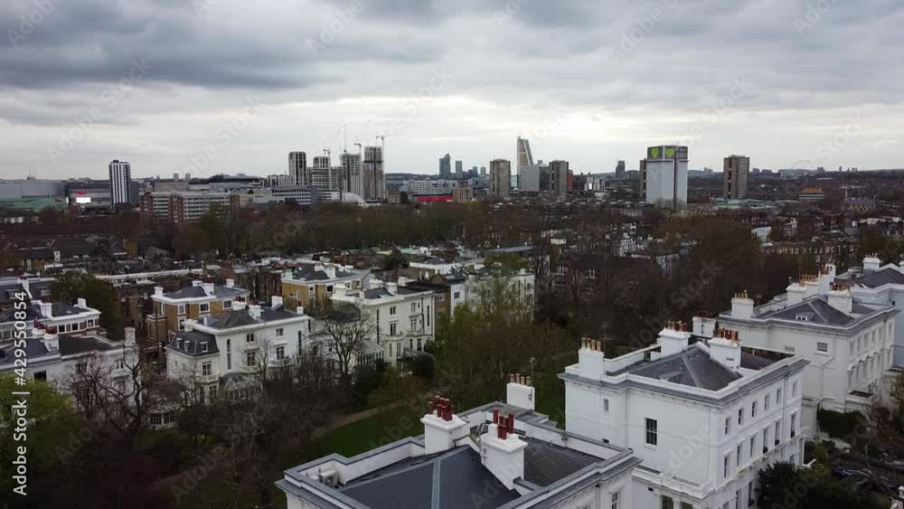 Ascending shot of Notting Hill district and construction site with skyscraper buildings in the central of London.