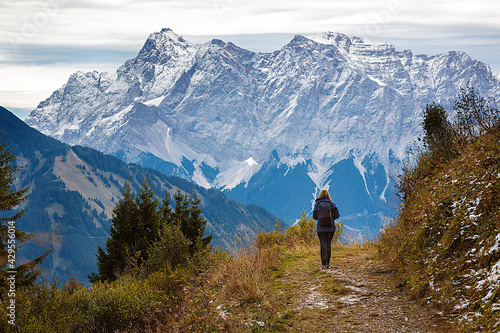 a woman is hiking in the direction of the Zugspitze near heiterwang