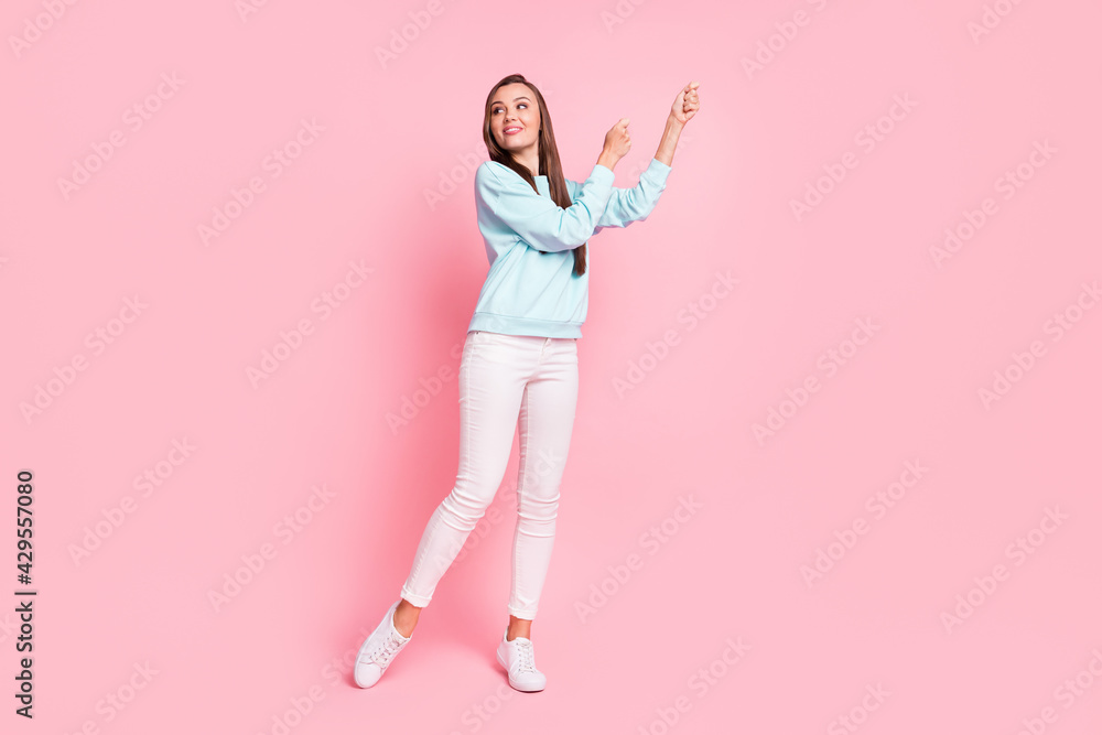 Full length photo of pretty person dance have nice weekend look empty space isolated on pink color background Full length photo of pretty person dance have nice weekend look empty space isolated on pink color background