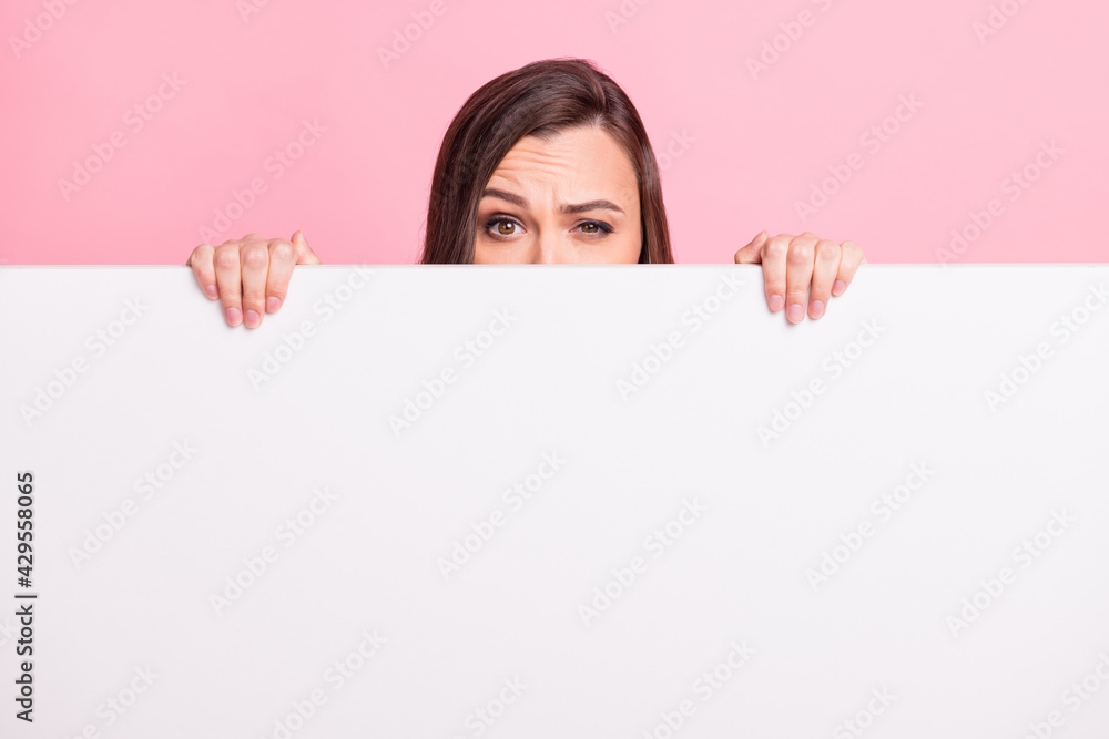 Close up photo of anonymous lady have doubts arms hold banner cover face isolated on pink color background Close up photo of anonymous lady have doubts arms hold banner cover face isolated on pink color background