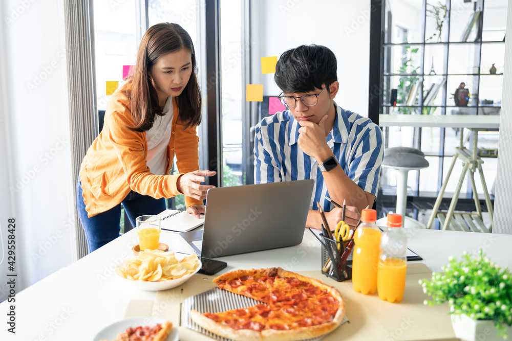 group of business people talking about project and prepare pizza and potato chips for having lunch in corporate together in office. group of business people talking about project and prepare pizza and potato chips for having lunch in corporate together in office.