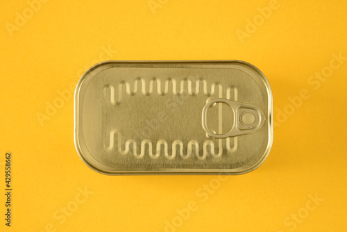 sealed sardine tin isolated on a yellow background 