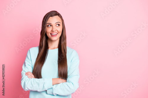 Photo of charming nice woman folded hands confident look empty space isolated on pink color background