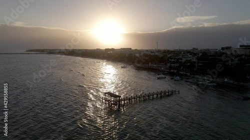 Pier or Dock in the ocean during sunset, silhouette aerial drone shot, Playa del Carmen, Yucatan, Mexico photo