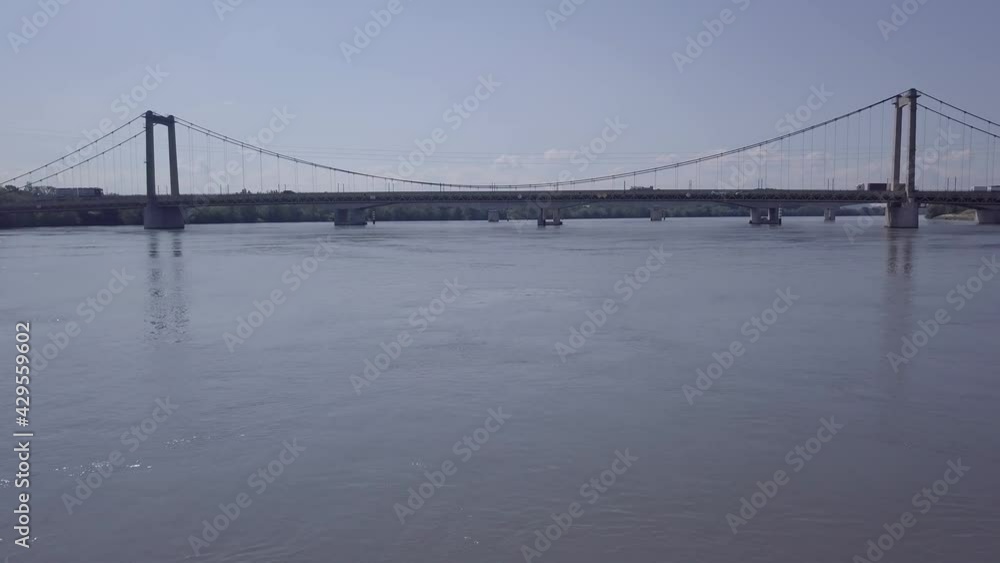 River Rhone transportation bridge crossing low angle aerial view over water towards suspension connection River Rhone transportation bridge crossing low angle aerial view over water towards suspension connection