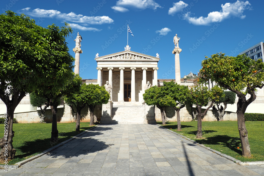 Beautiful neoclassic Academy of Athens public landmark building with beautiful spring clouds and deep blue sky, Athens historic centre, Attica, Greece