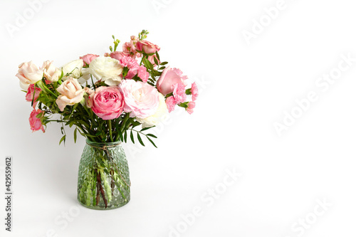 Beautiful flowers in vase on a table with white background. Women's, mother's day, love concept. Spring, summer season. © Mariia