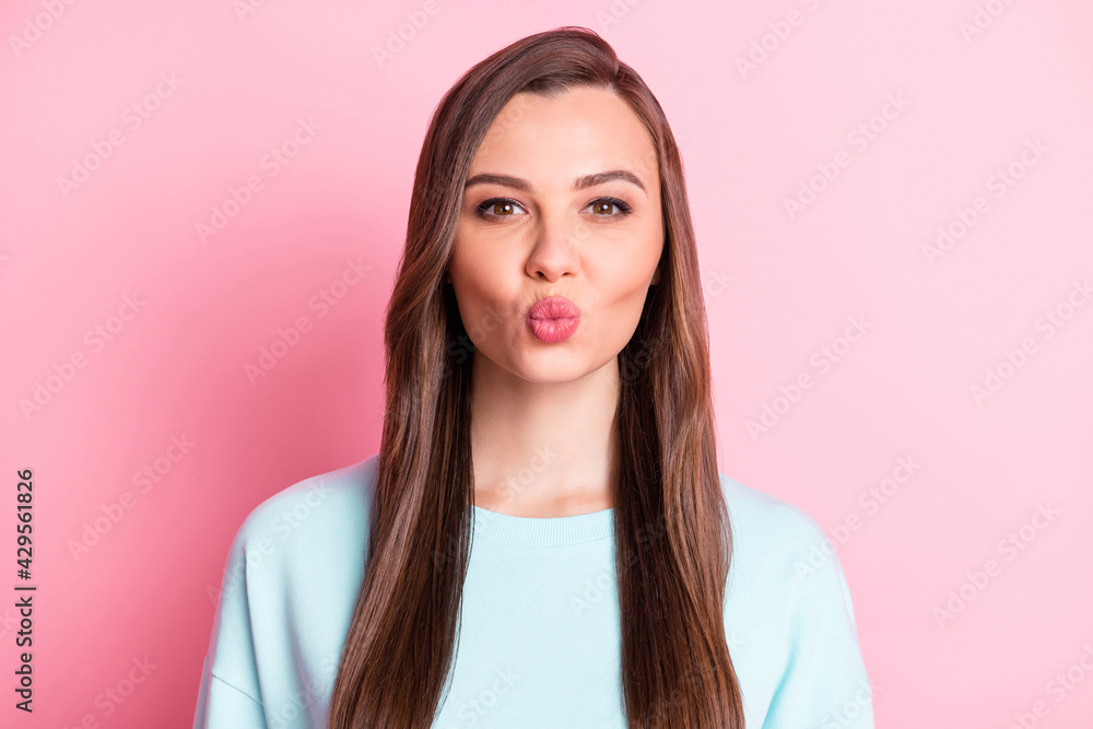 Photo of flirty charming young lady pouted lips send air kiss good mood isolated on pastel pink color background Photo of flirty charming young lady pouted lips send air kiss good mood isolated on pastel pink color background
