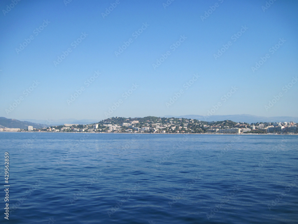 Scenic panoramic landscape of Cannes town of the sea country in the morning. Beautiful view of the sea and mountains. Seascape with coast of island. Skyline view from yacht in the sea.