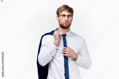 business man with a jacket on his shoulder blond glasses tie work