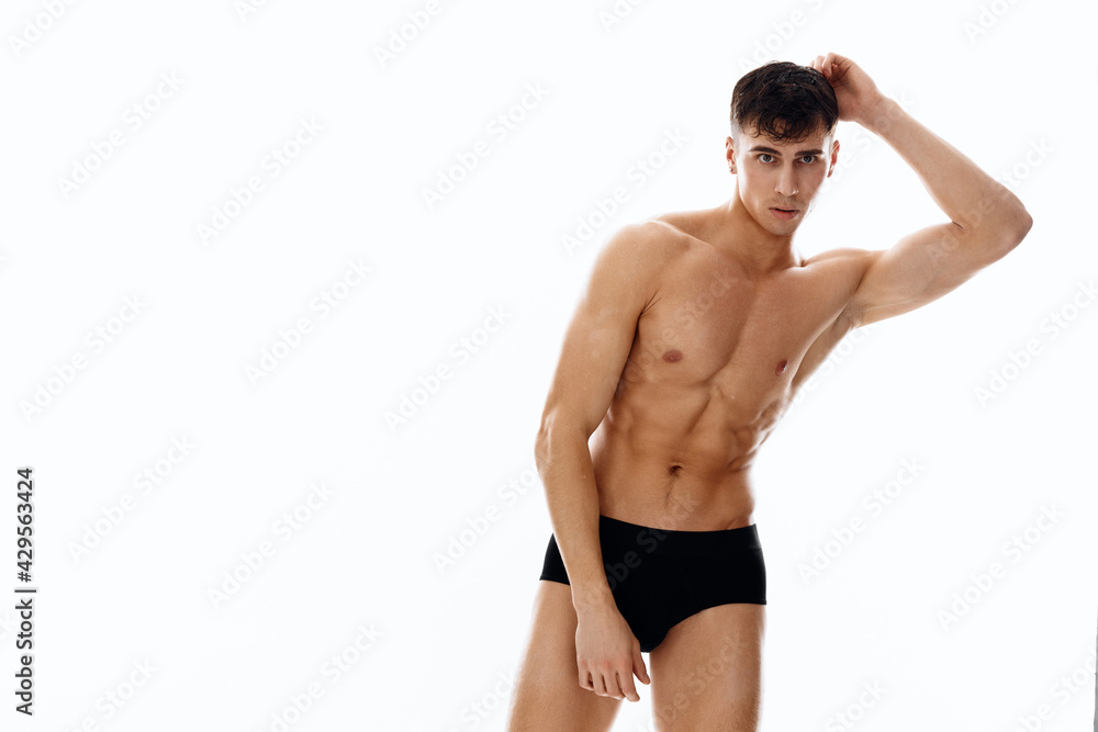 entertaining sports men in dark shorts posing on a light background entertaining sports men in dark shorts posing on a light background