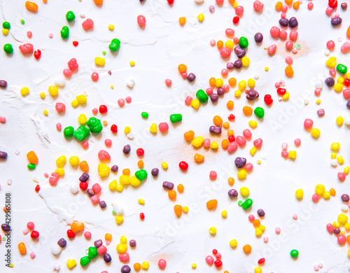 Fotografie Rainbow colored candy nerds sprinkled on a white background