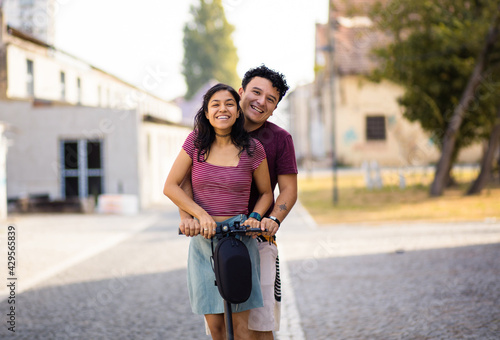 Young couple on electric scooter.