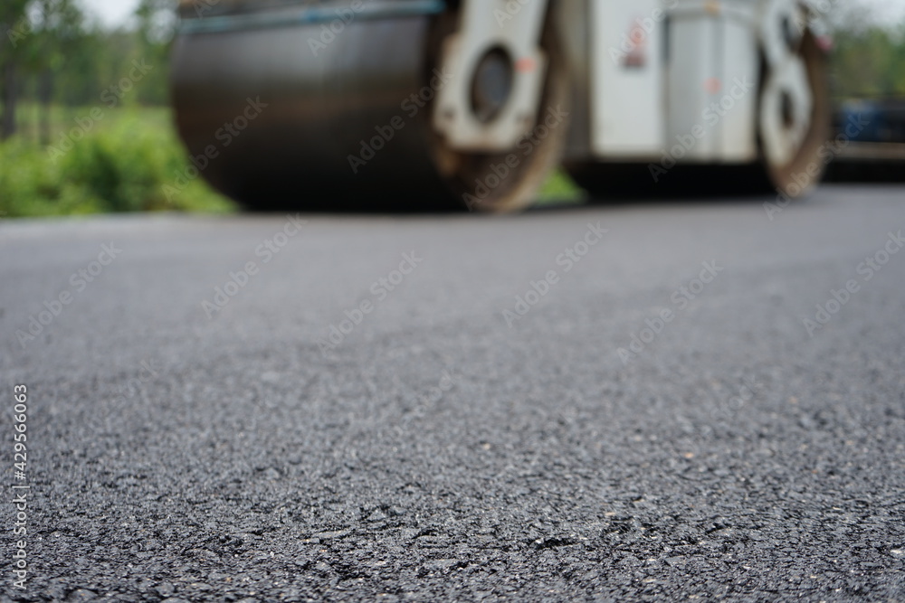 The image is blurred in the construction of asphalt road. The image is blurred in the construction of asphalt road.