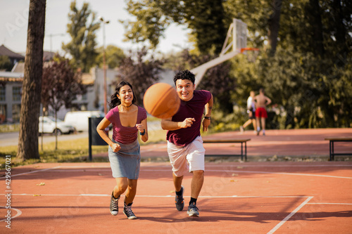 Young couple playing basketball. © liderina