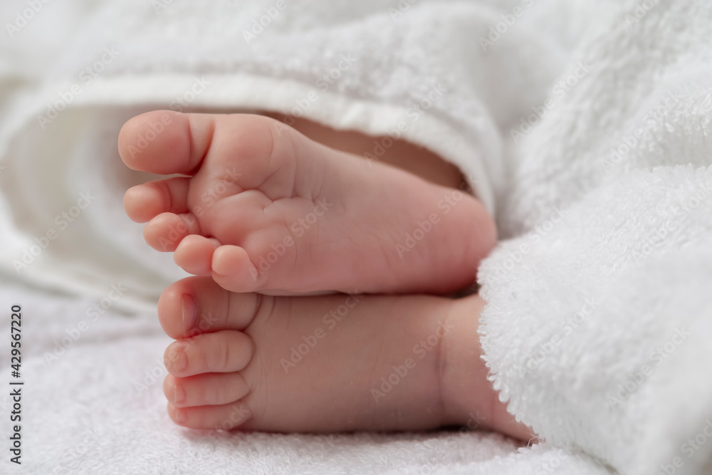 Close-up Shot of a Four Week Old Baby Boy Crossed Feet Over White Towel. Close-up Shot of a Four Week Old Baby Boy Crossed Feet Over White Towel.