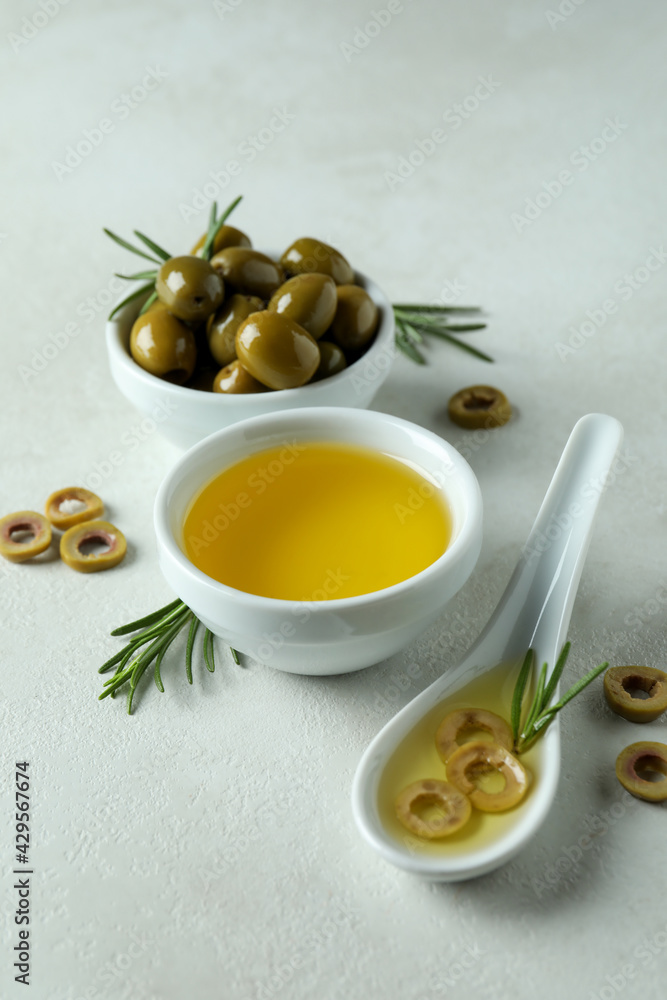 Bowls with olives and oil on white textured background Bowls with olives and oil on white textured background