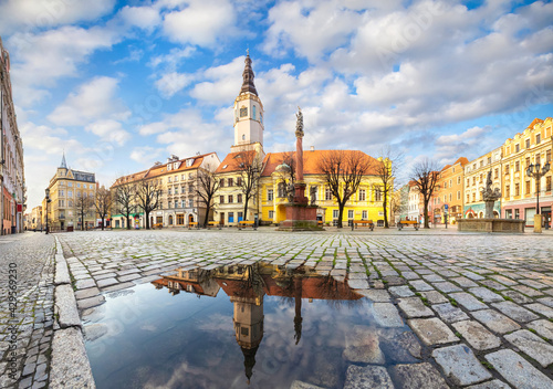 Swidnica, Poland. Panorama of Market Square (Rynek) with building of historic Town Hall reflecting in puddle