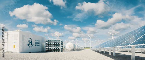 Modern hydrogen energy storage system accompaind by large solar power plant and wind turbine park in sunny summer afteroon light with blue sky and scattered clouds. 3d rendering. photo