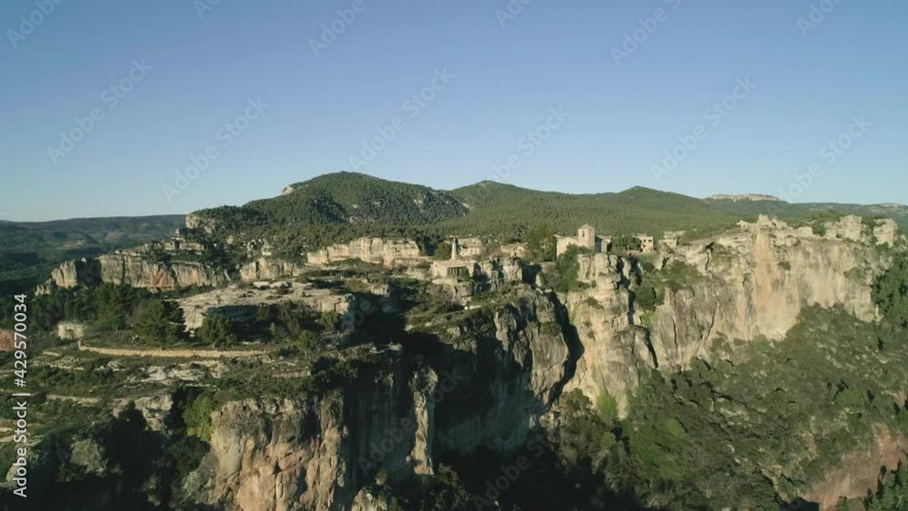 Scenic View Of Siurana Steep Mountains With Vegetation Against Blue Sky In Tarragona, Catalonia, Spain. - Aerial Shot Scenic View Of Siurana Steep Mountains With Vegetation Against Blue Sky In Tarragona, Catalonia, Spain. - Aerial Shot