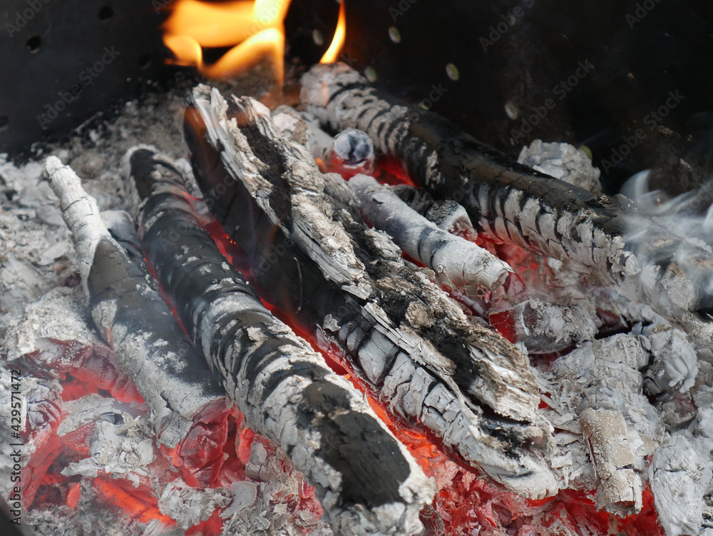 Obraz premium Almost extinguished fire left over from cooking on the fire. Summer day. Embers are visible