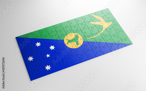 A jigsaw puzzle with a print of the flag of Christmas Island, pieces of the puzzle isolated on white background. Fulfillment and perfection concept. Symbol of national integrity. 3D illustration.