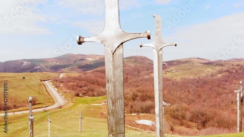 Didgori, Georgia - 17th april, 2021: Rising view giant swords in ground. Didgori memorial monument. photo