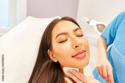 Young woman professionally cleansing her skin