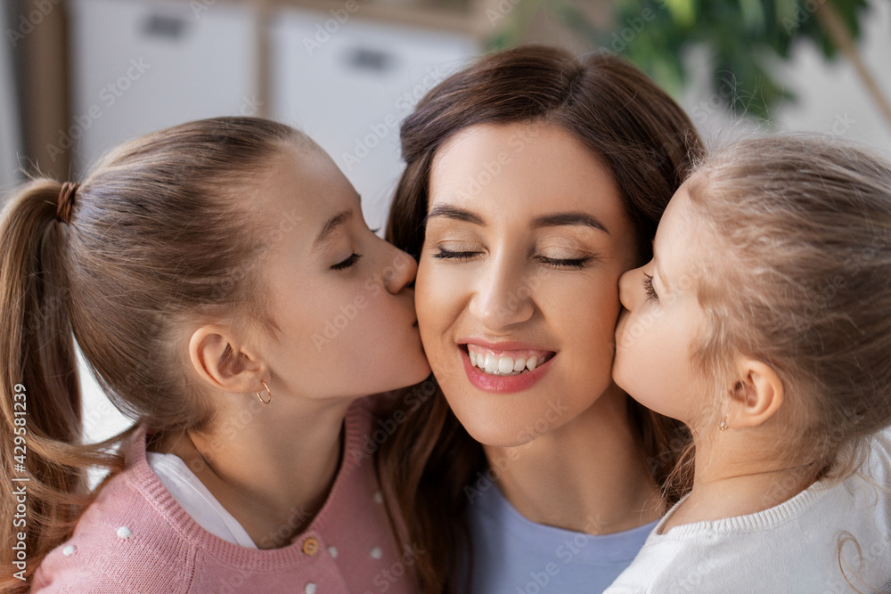 people, family and love concept - two daughters kissing happy mother at home people, family and love concept - two daughters kissing happy mother at home