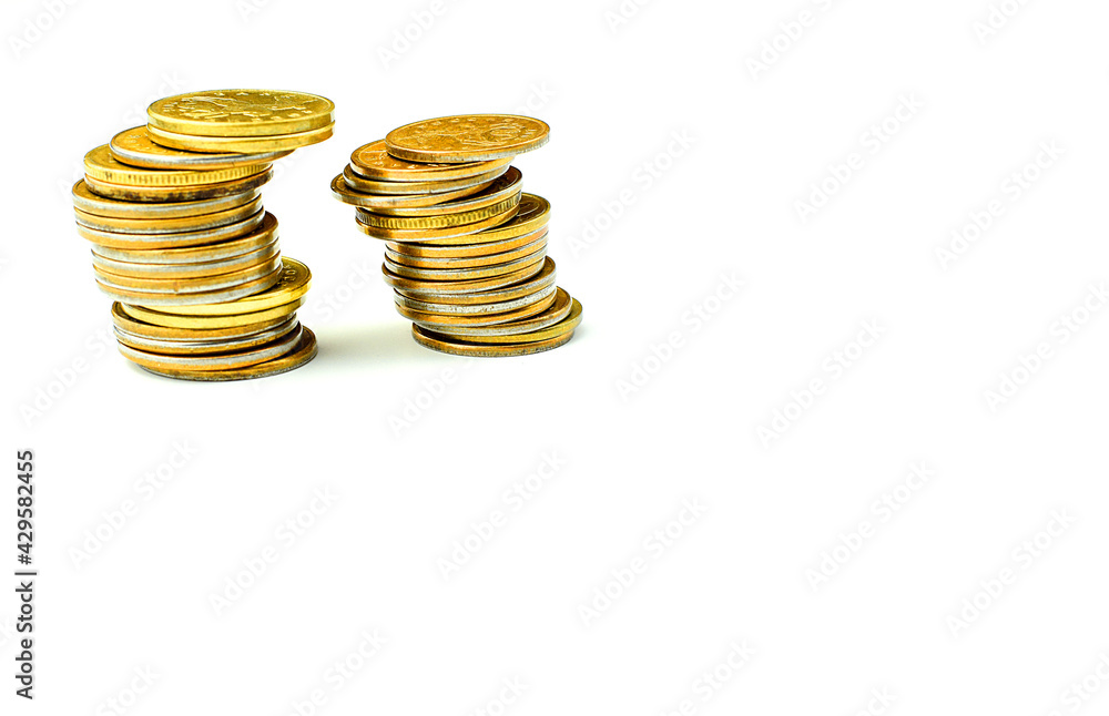 Money coins in a stack tilted to the side isolated on a white background. Coins are falling. Financial crisis. The fall in the exchange rate. Selective focus. Copy space for text. Money coins in a stack tilted to the side isolated on a white background. Coins are falling. Financial crisis. The fall in the exchange rate. Selective focus. Copy space for text.