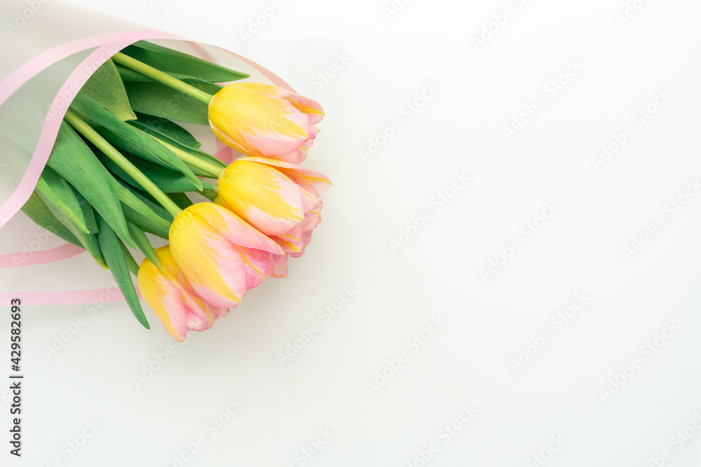 bouquet of tender pink tulips on a white background, copy space, place for text