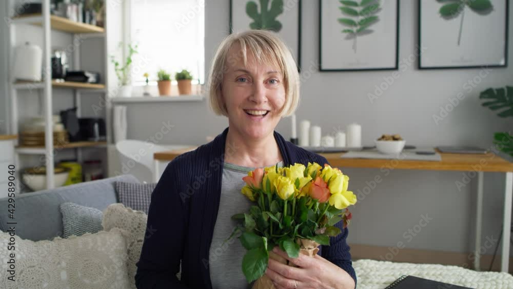 Video portrait of senior woman with bouquet of flowers. Shot with RED helium camera in 8K. Video portrait of senior woman with bouquet of flowers. Shot with RED helium camera in 8K.
