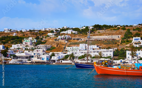 Beautiful summer day on Greek island  Mykonos  Greece. Fishing boats at jetty. Whitewashed houses  mediterranean lifestyle  vacations  summer. 