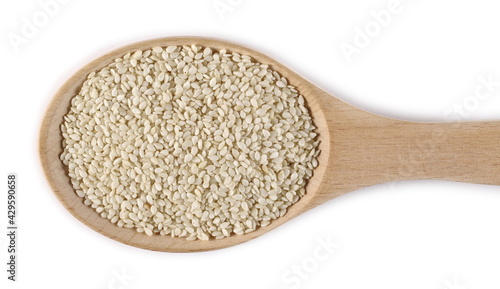 Sesame seeds in wooden spoon isolated on white background, top view