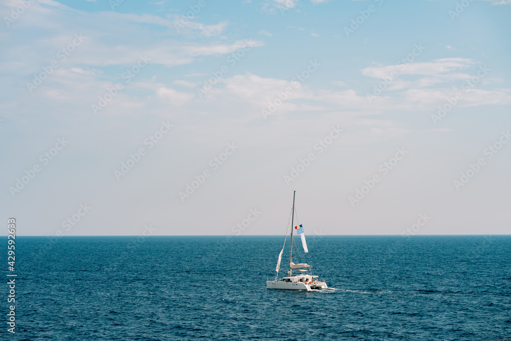 White sailing yacht on the open sea on a bright sunny day