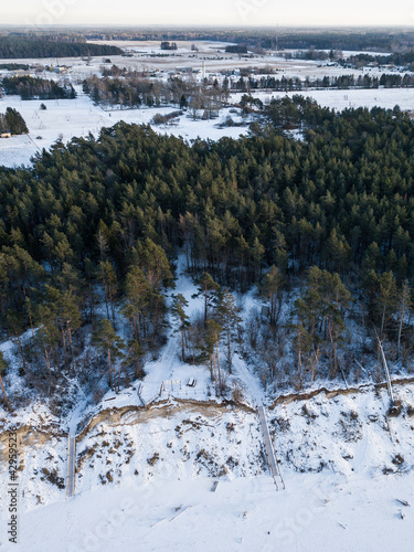 Aerial view of the steep shore of the Baltic Sea in Jurkalne in winter, Latvia.