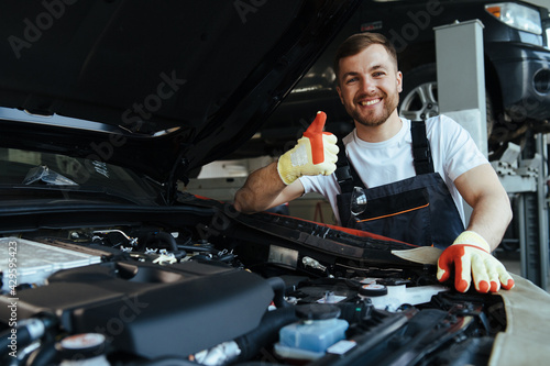 technician working on checking and service car in  workshop garage