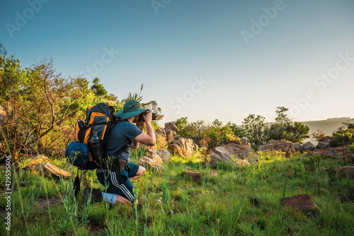 Male hiker taking a photograph in Suikerboschfontein  in Mpumalanga, South Africa. November 2018 photo